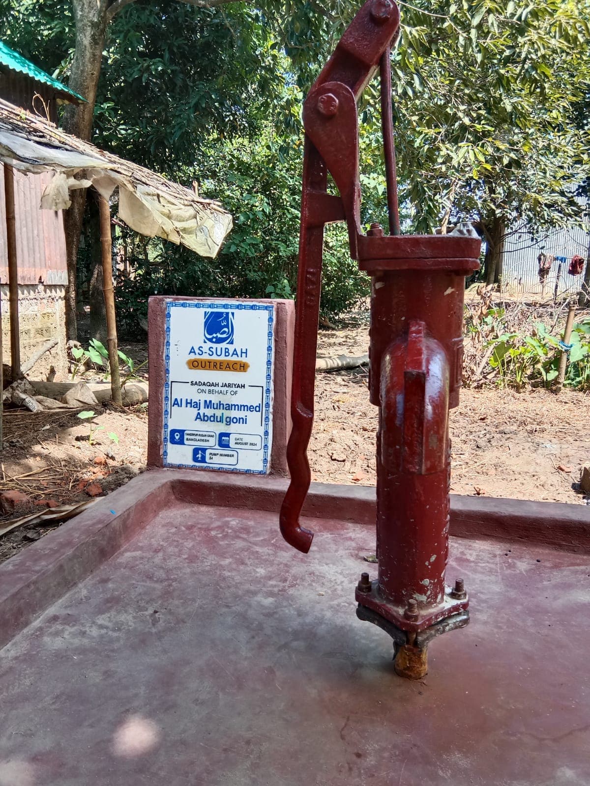 Children and families at a water distribution point with storage containers
